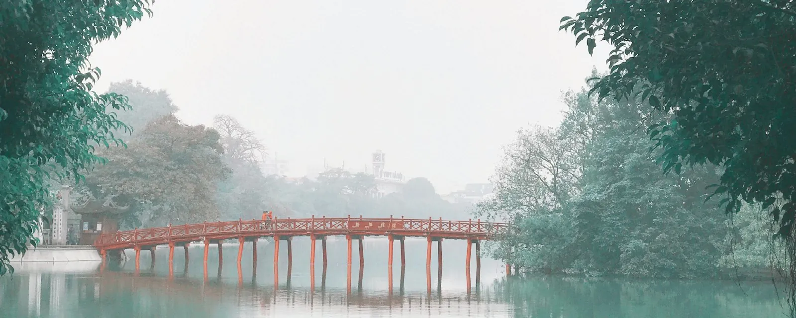 The red Huc Bridge on Hoan Kiem Lake in Hanoi, in morning mist